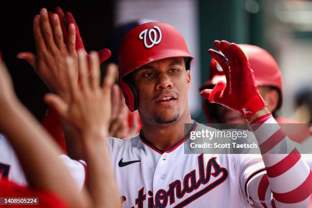 Juan Soto of the Washington Nationals celebrates with teammates after hitting a three run home run against the Seattle Mariners during the ninth...