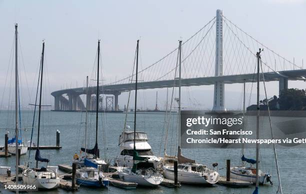 Sailboats are moored at the Clipper Cove marina on Treasure Island in front of the new Bay Bridge span in San Francisco, Calif. On Sept. 8, 2016....