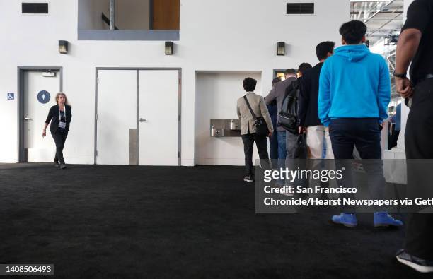 Men attending the TechCrunch Disrupt conference stand in a long line to use the restroom while there's no waiting for the women's room in San...