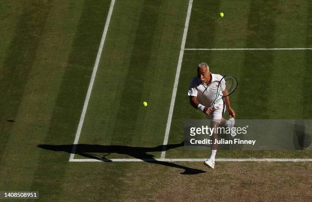 Mansour Bahrami of France hits back a spare ball as he chases down another ball against Todd Woodbridge of Australia and Cara Black of Zimbabwe...