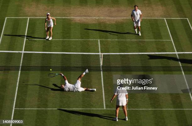 Mansour Bahrami of France plays a shot from the floor against Todd Woodbridge of Australia and Cara Black of Zimbabwe during their Invitation Mixed...