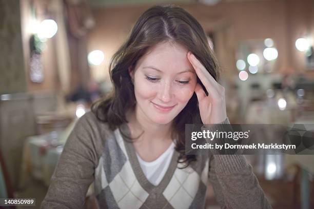 young woman in restaurant - verlegen stockfoto's en -beelden