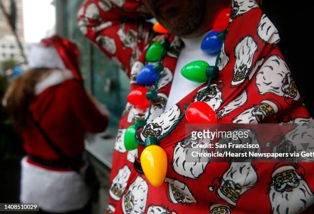 Tony Cicala wears a strand of Christmas lights for the annual Santacon romp on Union Square in San Francisco, Calif. On Saturday, Dec. 10, 2016.