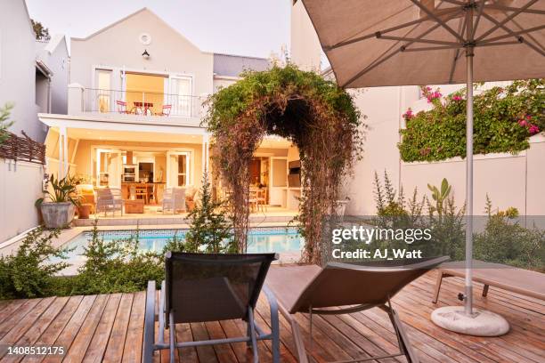 patio and pool in the back yard of a house in summer - backyard deck stock pictures, royalty-free photos & images