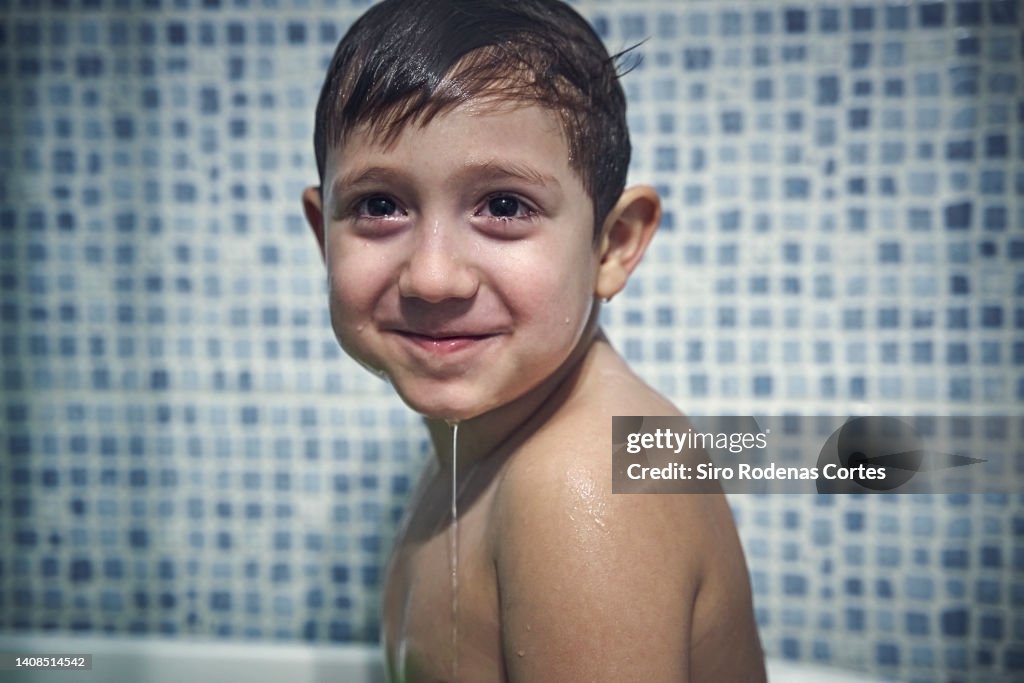 Flash portrait of boy in bathtub