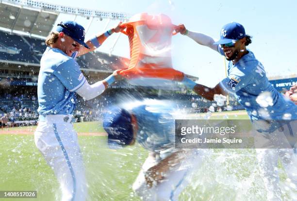 Hunter Dozier of the Kansas City Royals is doused with water by Bobby Witt Jr. #7 and MJ Melendez after the Royals defeated the Detroit Tigers 5-2 to...