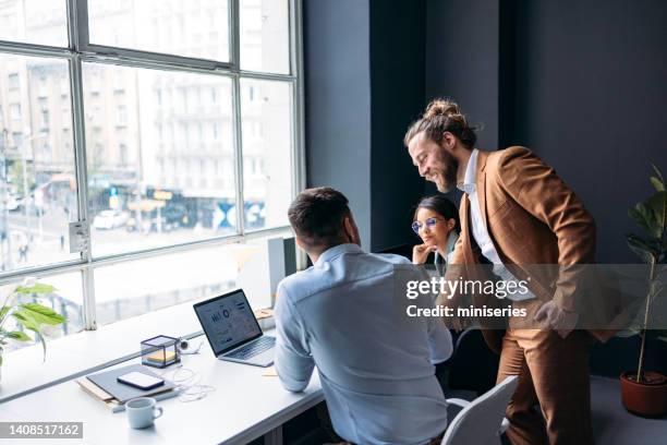 businesspeople working together on a new project at their company - bossy stock pictures, royalty-free photos & images