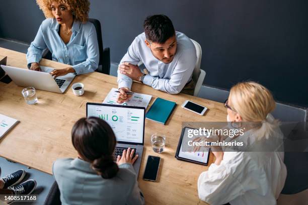 serious group of businesspeople on a meeting at their company - coworking spaces stock pictures, royalty-free photos & images