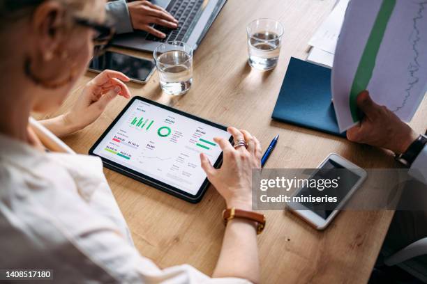 group of businesspeople on a meeting at their company - people sitting around table top view stock pictures, royalty-free photos & images