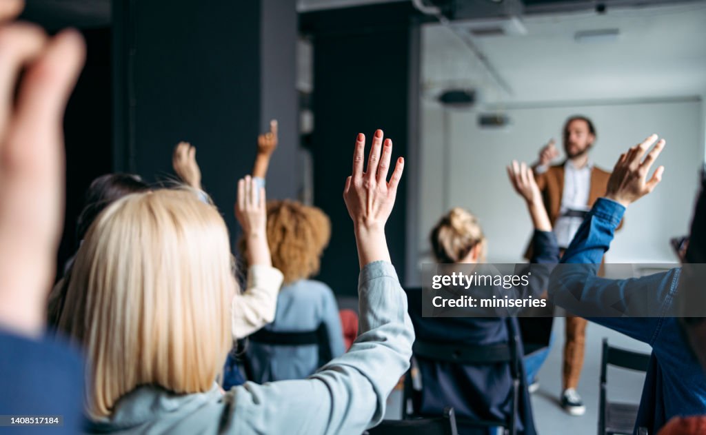 Business Peoples Volunteers To Answer A Question During A Seminar