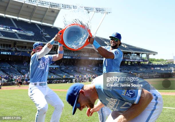 Hunter Dozier of the Kansas City Royals is doused with water by Bobby Witt Jr. #7 and MJ Melendez after the Royals defeated the Detroit Tigers 5-2 to...