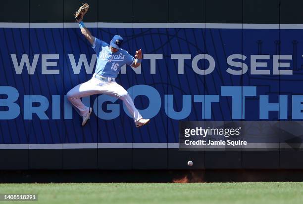 Andrew Benintendi of the Kansas City Royals is unable to make a catch at the wall during the game against the Detroit Tigers at Kauffman Stadium on...