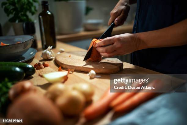 preparing a roasted root vegetables - chopping stock pictures, royalty-free photos & images