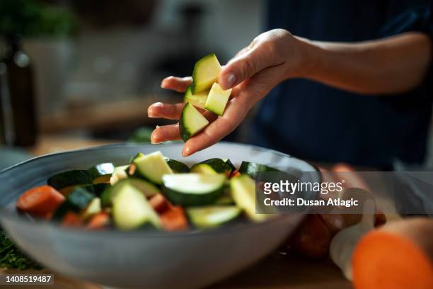 preparing a roasted root vegetables - courgette stock pictures, royalty-free photos & images