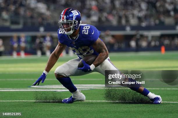 Devontae Booker of the New York Giants cuts back against the Dallas Cowboys during an NFL game at AT&T Stadium on October 10, 2021 in Arlington,...