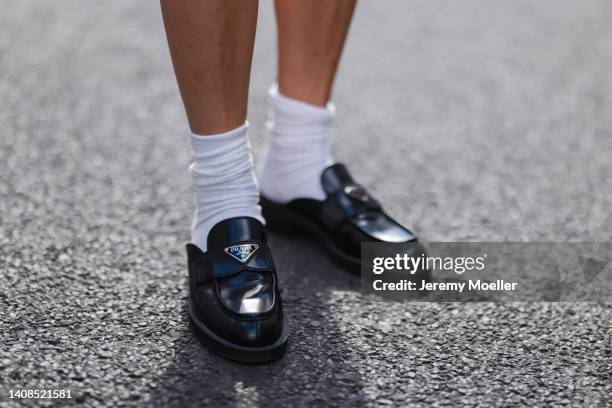 Anna Winter is seen wearing Prada black leather loafer and Jil Sander white socks on July 12, 2022 in Berlin, Germany.