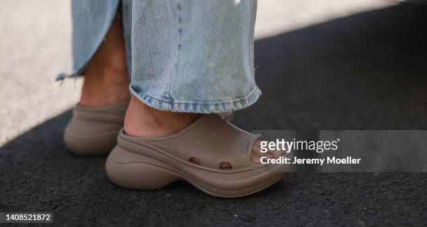 Anna Winter is seen wearing Balenciaga Rubber Pool slide sandals in beige and Source Unknown wide leg denim jeans on July 12, 2022 in Berlin, Germany.