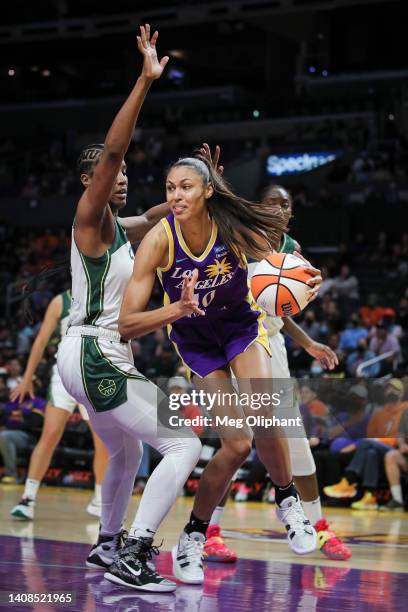 Olivia Nelson-Ododa of the Los Angeles Sparks handles the ball defended by Jantel Lavender of the Seattle Storm in the second half at Crypto.com...