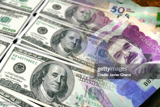 cash bills of dollars and colombian pesos - colombian peso stock pictures, royalty-free photos & images