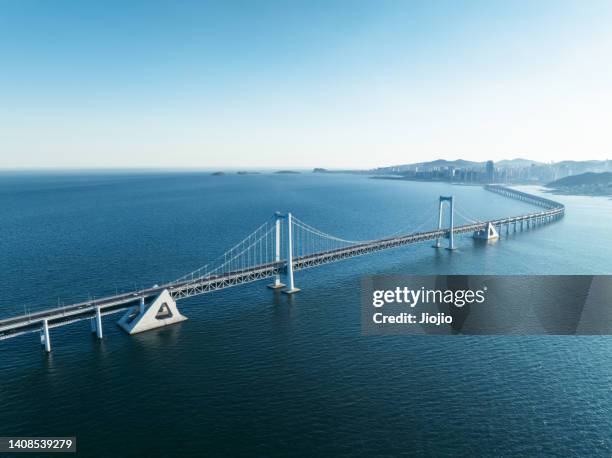 modern bridge - beach bird's eye perspective stock pictures, royalty-free photos & images