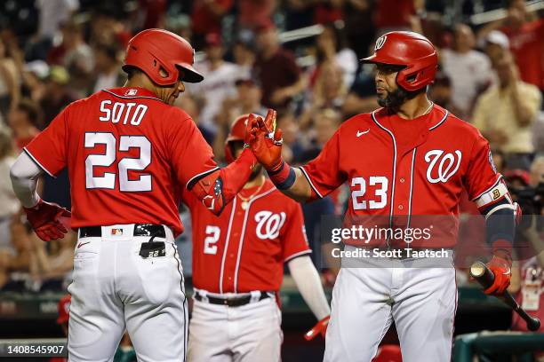 Juan Soto of the Washington Nationals celebrates with Nelson Cruz after hitting a home run against the Seattle Mariners during the ninth inning of...