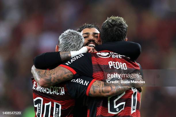 Giorgian de Arrascaeta of Flamengo celebrates after scoring the second goal of his team with teammates Gabriel Barbosa and Pedro during a Copa Do...