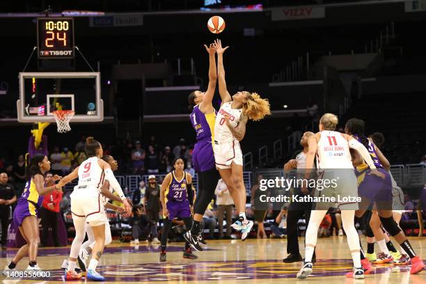 Liz Cambage of the Los Angeles Sparks and Shakira Austin of the Washington Mystics jump for the opening tip during a game at Crypto.com Arena on July...