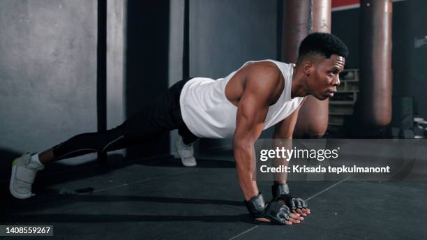 african man doing push-up before beginning daily boxing session. - bodyweight training stock pictures, royalty-free photos & images