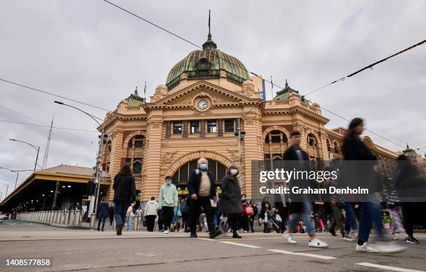 Commuters make their way from Flinders Street Station on July 14, 2022 in Melbourne, Australia. Victorian Health authorities are recommending...