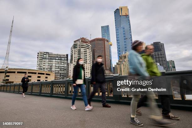 Members of the public wear face masks as they commute around the city on July 14, 2022 in Melbourne, Australia. Victorian Health authorities are...
