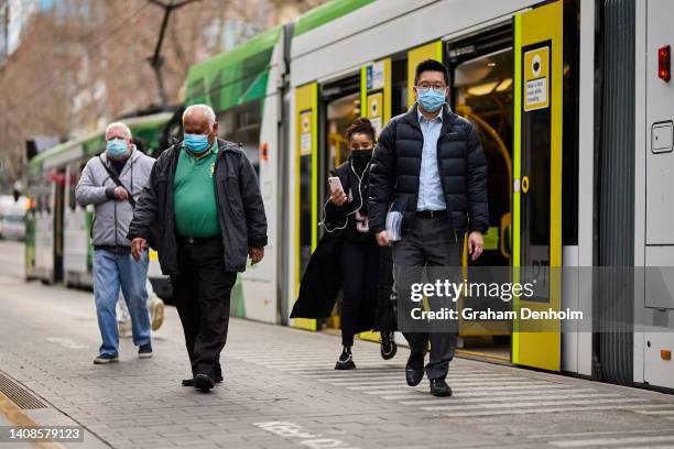Members of the public wear face masks as they commute around the city on July 14, 2022 in Melbourne, Australia. Victorian Health authorities are...