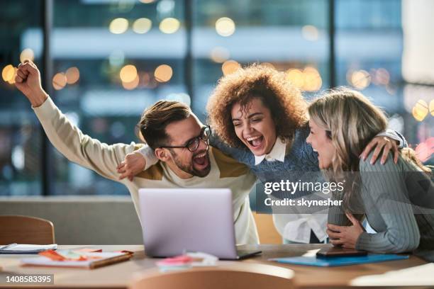 cheerful creative team working on laptop in the office. - boa notícia imagens e fotografias de stock