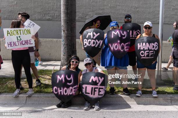 An abortion rights activist holds a sign at a protest in support of abortion access, March To Roe The Vote And Send A Message To Florida Politicians...