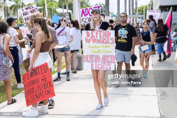 An abortion rights activist holds a sign at a protest in support of abortion access, March To Roe The Vote And Send A Message To Florida Politicians...