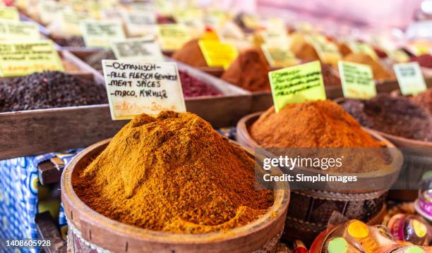 a pile of asian aromatic spices in a wooden container at the market. osmanish spices i wooden bowl. - spice market stock pictures, royalty-free photos & images