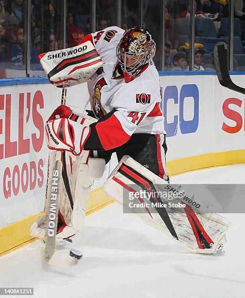 Craig Anderson of the Ottawa Senators clears the puck away from behind the net during the game against the New York Islanders at Nassau Veterans...