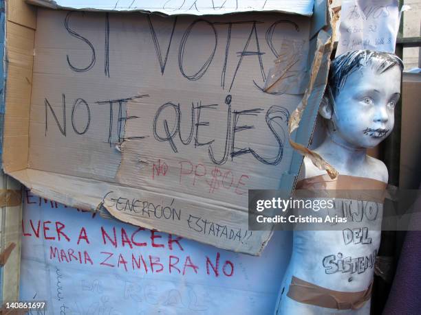 Next to a mannequin with sewn mouth a sign says, if you vote do not complain, camp of the indignants on Puerta del Sol, on March 15, 2011 the...