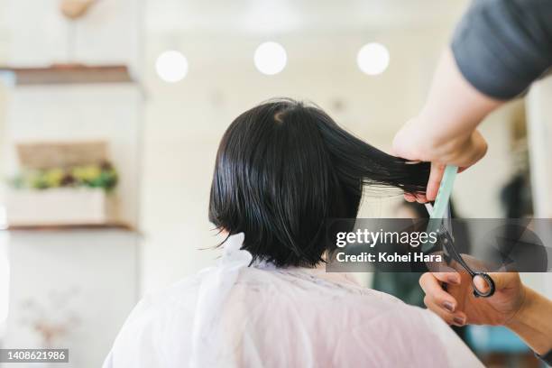 mother cutting her daughter's hair - cut hair stock pictures, royalty-free photos & images