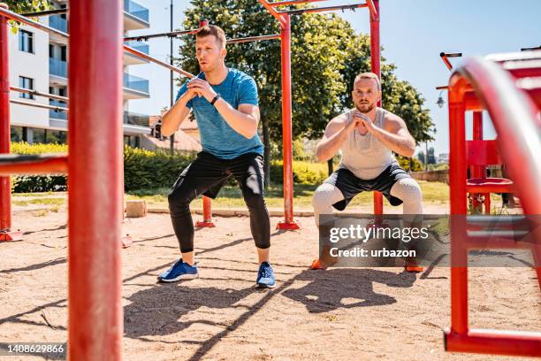 two young men training outdoors - bodyweight training stock pictures, royalty-free photos & images