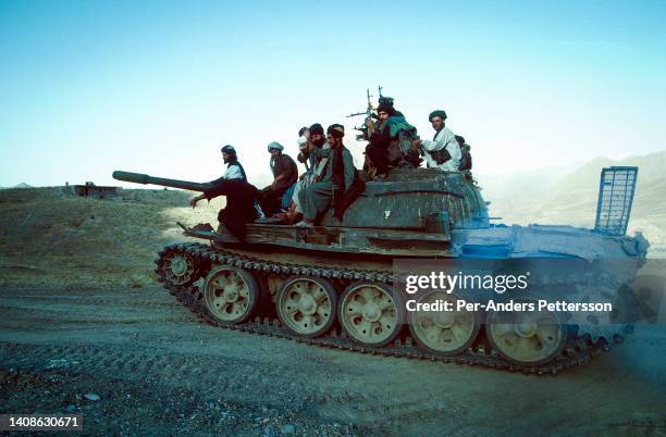 Unidentified Taliban soldiers rides on a tank on July 25, 1996 outside Kabul, Afghanistan. The Taliban took over most of the country in late 1996,...