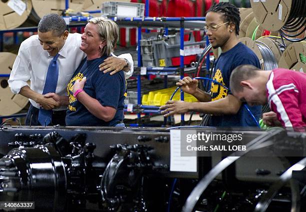 President Barack Obama greets employees during a tour of the Daimler Trucks North America Manufacturing plant prior to speaking on the economy and...