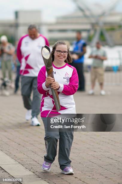 Batonbearer Freya Cowie carries the Queen's Baton during the Birmingham 2022 Queen's Baton Relay visit to the River Tees Watersports Centre in...