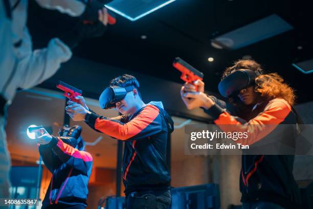 2 asian esports teams playing vr shooting videogame competing each other in grand final on stage.  videogame championship arena. cyber games tournament event - shooting a weapon bildbanksfoton och bilder
