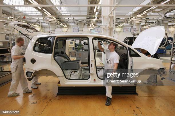 Workers assemble Volkswagen Touran and Tiguan cars at the Volkswagen factory on March 7, 2012 in Wolfsburg, Germany. In 2011 Volkswagen achieved...