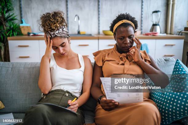 lesbian couple going through financials problems - couple relationship problem stock pictures, royalty-free photos & images