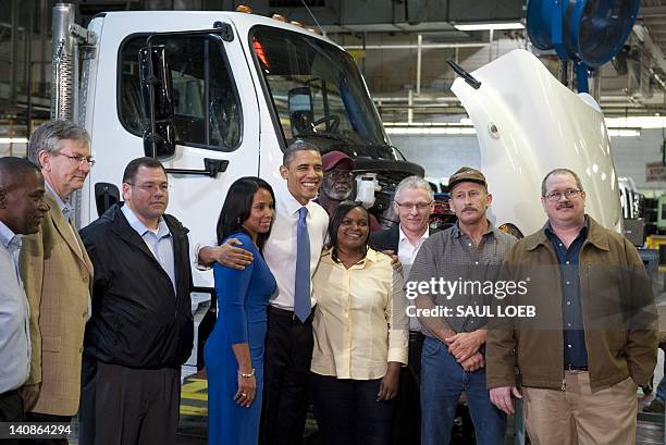 President Barack Obama takes a photograph with employees as he tours the Daimler Trucks North America Manufacturing plant prior to speaking on the...