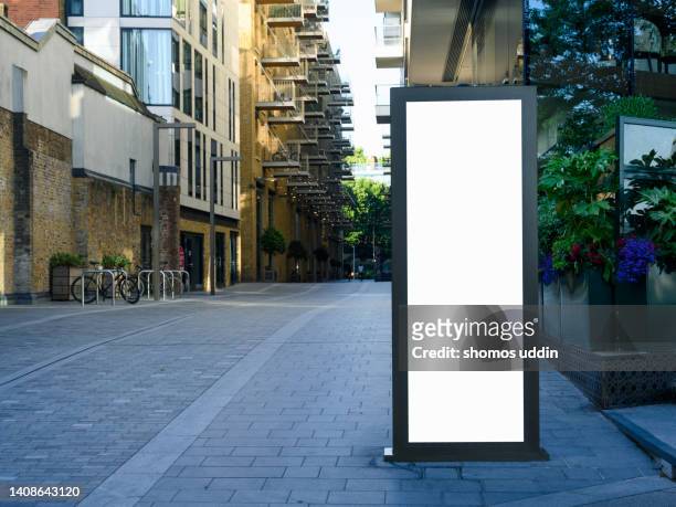 blank digital billboard amidst residential buildings in london - lightbox stock-fotos und bilder