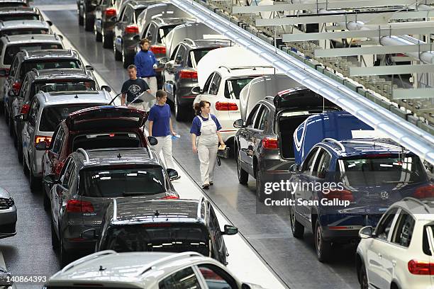 Workers process finished Volkswagen Tiguan cars at the Volkswagen factory on March 7, 2012 in Wolfsburg, Germany. In 2011 Volkswagen achieved record...