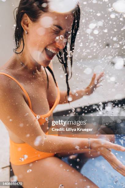 close-up portrait of happy woman with splashes of water. - droplet sea summer stockfoto's en -beelden