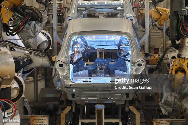 Robost weld the bodies of Volkswagen Tiguan cars at the Volkswagen factory on March 7, 2012 in Wolfsburg, Germany. In 2011 Volkswagen achieved record...